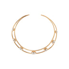 Gold and shell collar necklace on a white background