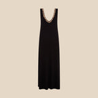 Black sleeveless dress with decorative shells on a white background